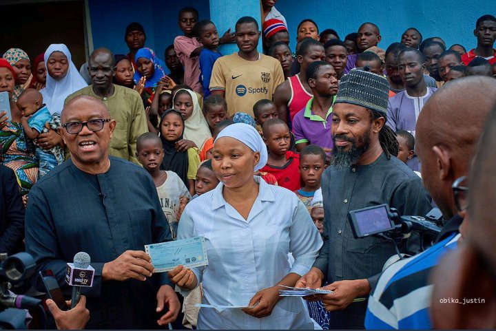 Reactions as the crowd greets Obi after he returns to an Abuja health center to make donations